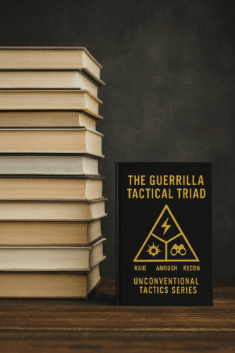 Photorealistic image of a stack of hardcover books about one foot high next to the black-and-yellow cover of “The Guerrilla Tactical Triad,” set on a wooden surface against a dark background.