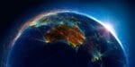 View of Earth from space focused on Australia and Southeast Asia, with glowing network lines and light trails showing global digital and communication connections.