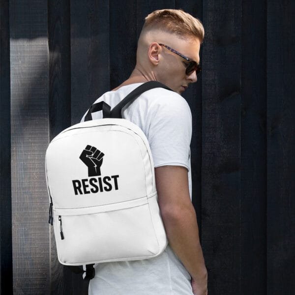 White backpack with raised fist and RESIST text worn by male model