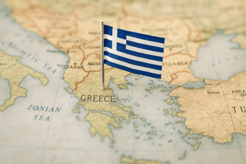 Map of southeastern Europe focused on Greece with the Greek flag pinned into the territory.