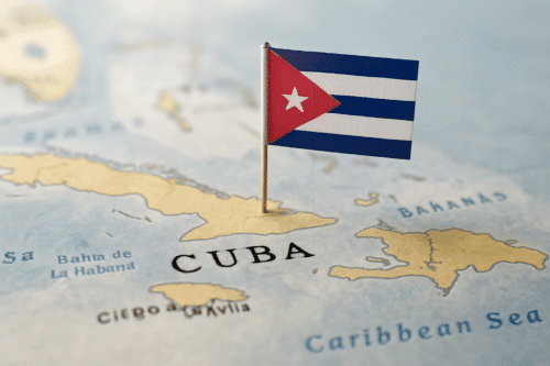 Map of the Caribbean focused on Cuba with the Cuban flag pinned firmly in the center of the island’s landmass.