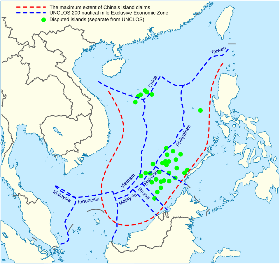 Map of the South China Sea showing China’s dashed red claim line, overlapping UNCLOS EEZ boundaries of nearby states in blue, and disputed islands marked in green.