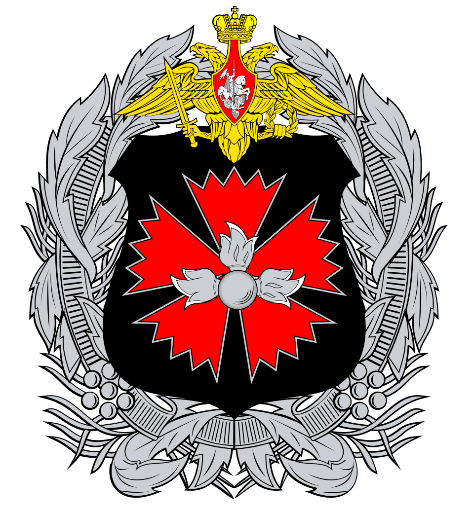 Illustrated military-style emblem featuring a black shield with a red eight-pointed star and silver grenade at the center, topped by a gold double-winged crest and surrounded by a silver laurel wreath.