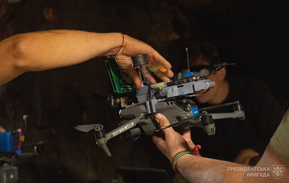 A Ukrainian soldier from the Presidential Brigade operates a reconnaissance drone during combat operations near Vovchansk in September 2024, illustrating the fusion of human judgment and unmanned systems that defines Ukraine's multi-domain campaign.